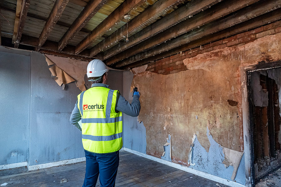 Fire damaged room with inspector